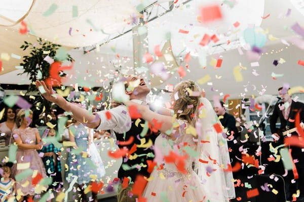 Bride and groom being showered in confetti on the dance floor - Picture by Folega Photography