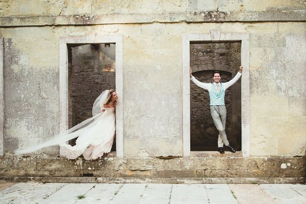 Bride and groom standing in doorways - Picture by Maryanne Weddings
