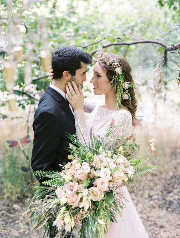 Bride with hand on groom's face