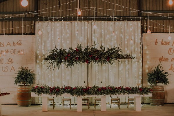 Large foliage hanging installation over wedding top table