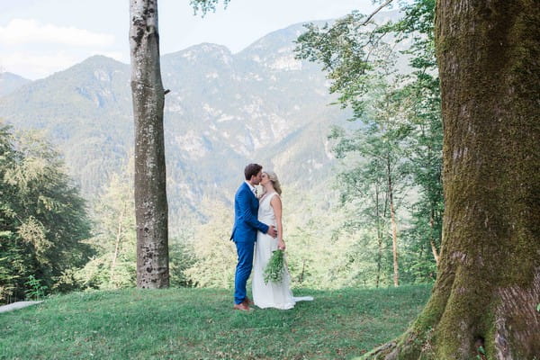 Bride and groom kissing in front of incredible view in Italy