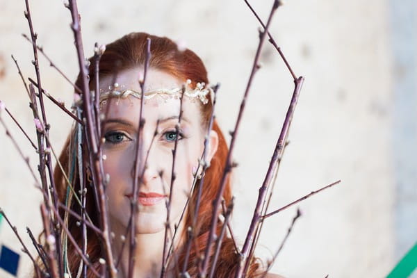 Bride's face behind twigs