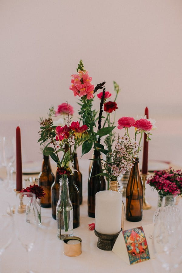Bottles of flowers on wedding table