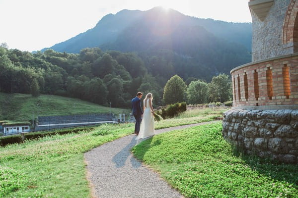 Bride and groom walking in grounds of Count Ceconi Castle in Italy