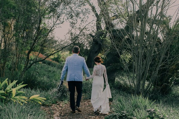 Bride and groom walking holding hands at Langverwagt