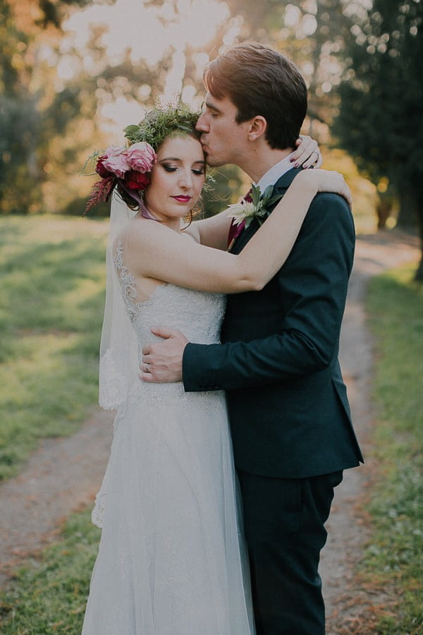Groom kissing bride on the head