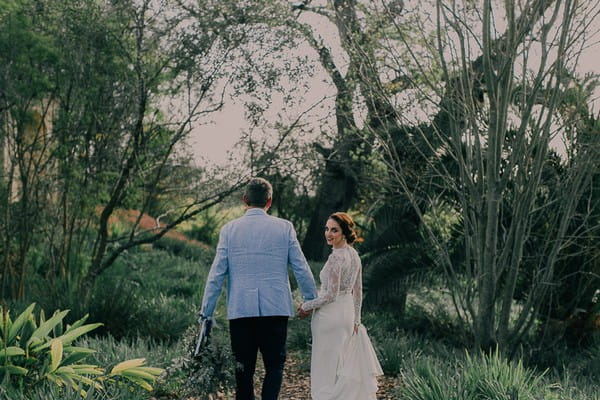 Bride and groom walking in grounds of Langverwagt