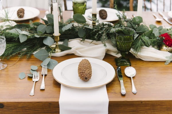 Pine cone on plate at wedding place setting