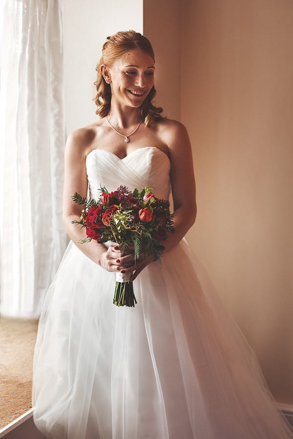 Bride holding red bouquet