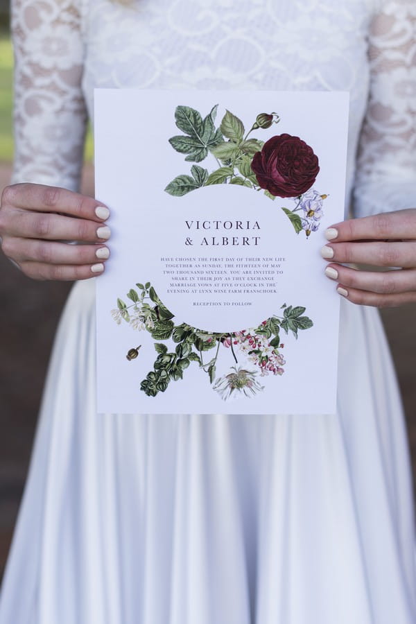 Bride holding winter wedding invitation