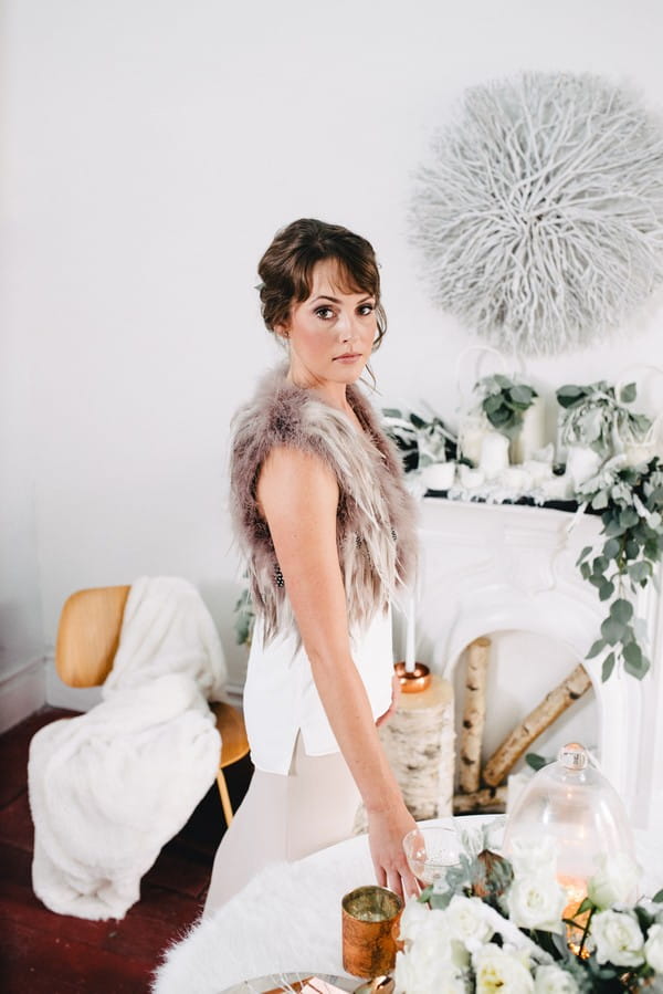 Bride wearing fur and feather shrug