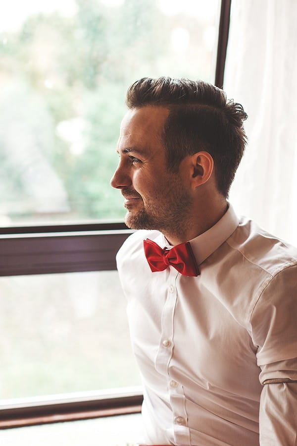 Groom wearing red bow tie