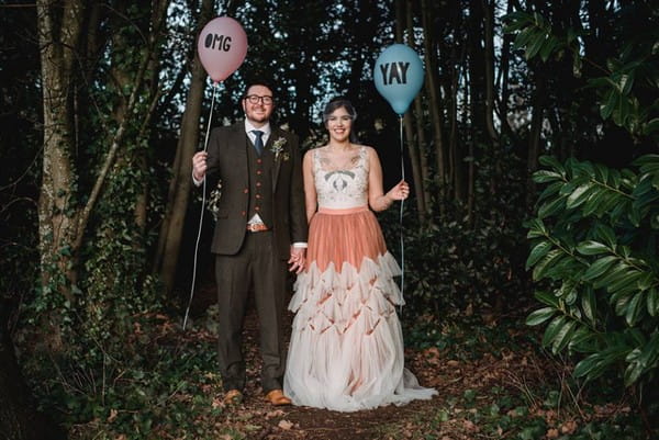 Bride and groom holding balloons in the woods - Picture by Esme Mai Photography