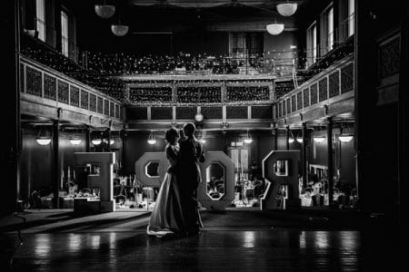 Bride and groom dancing on stage at wedding venue - Picture by Penny Young Photography