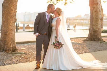 Bride and groom kissing between two trees - Picture by James and Kerrie Photography