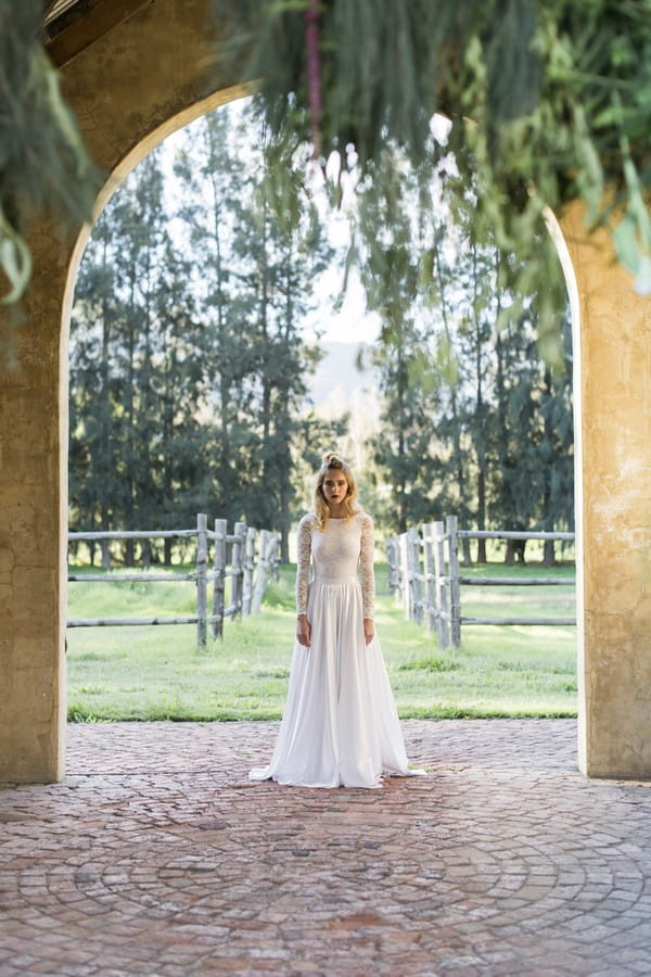 Bride standing under arch