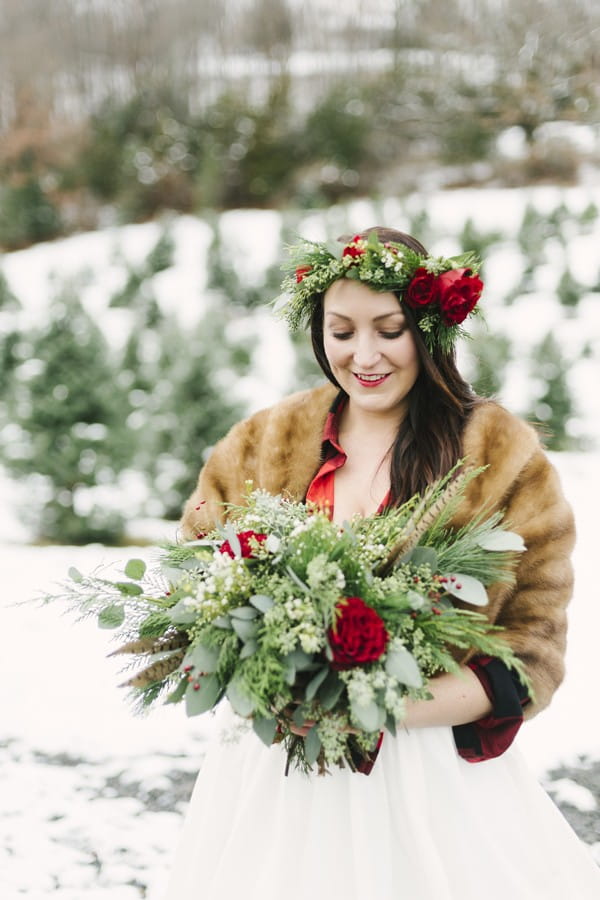 Bride with rose and foliage crown holding winter wedding bouquet