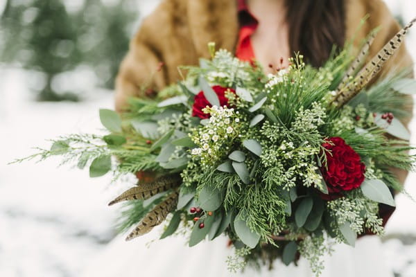 Brides winter wedding bouquet with foliage and roses