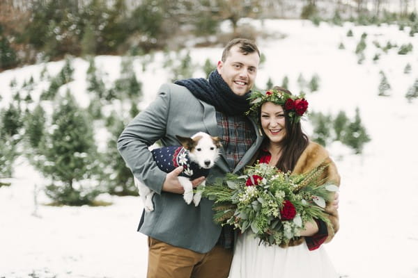 Bride with groom holding a dog