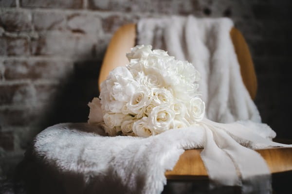 White bouquet on fur on chair