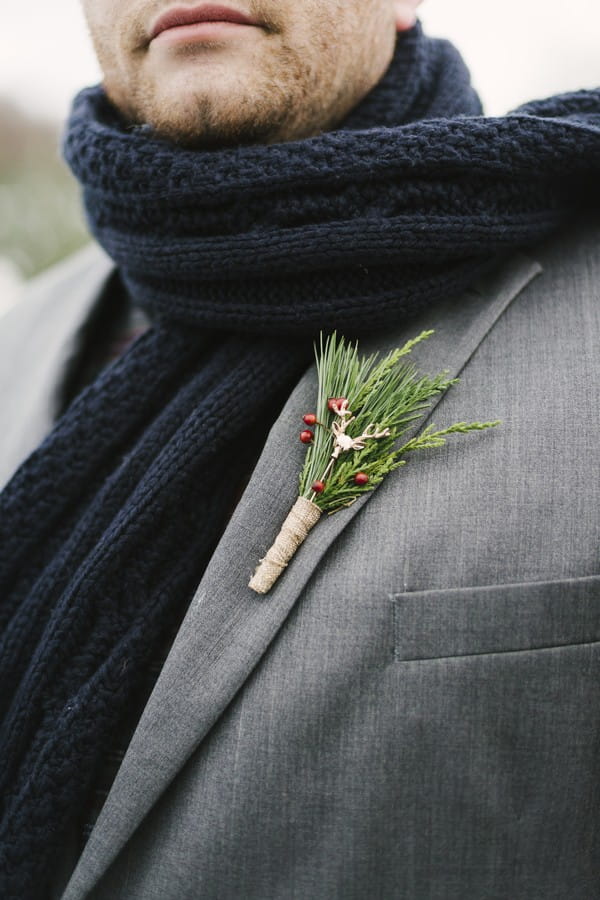 Deer pin in groom's winter buttonhole