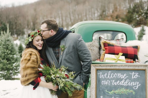 Groom kissing bride on the head