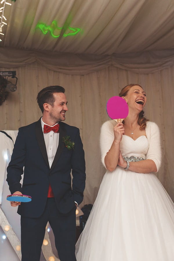 Bride laughing as she plays Mr and Mrs game