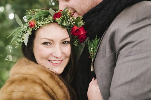 Bride with rose and foliage crown smiling