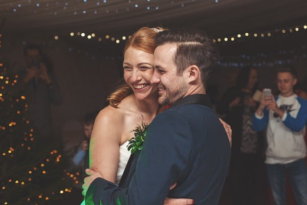 Bride and groom smiling on dance floor