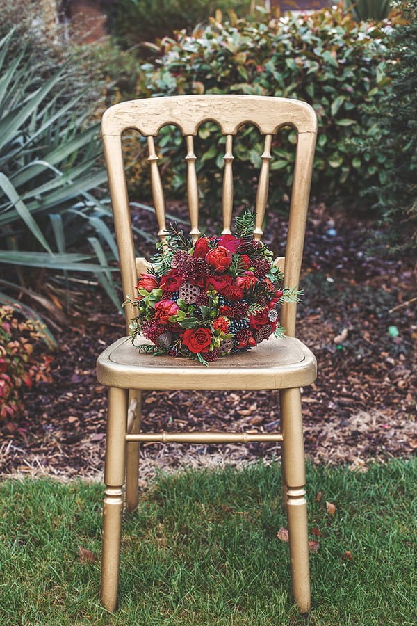 Red wedding bouquet on chair