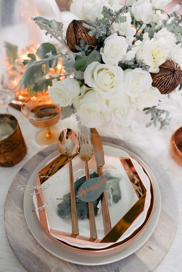 Wedding place setting with white and copper styling
