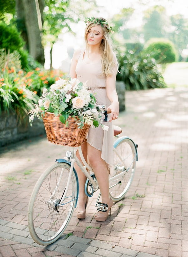 Bride on Bicycle with Basket of Summer Flowers and Foliage