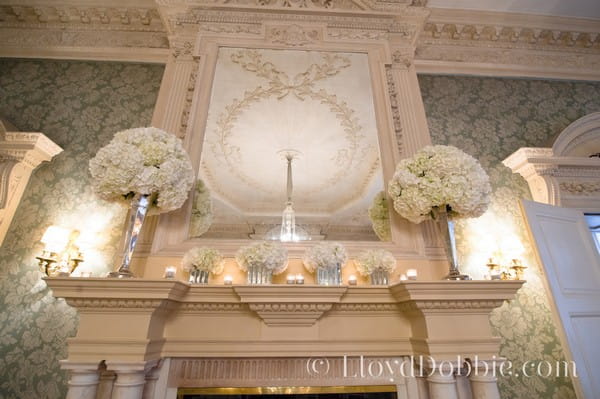 Different Height Floral Arrangements on Mantelpiece