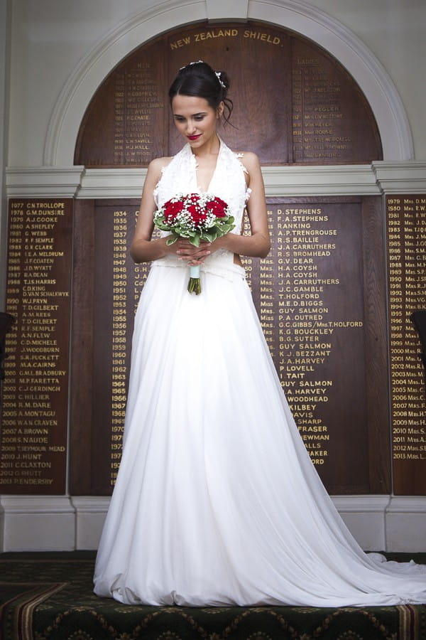 Bride Holding Winter Wedding Bouquet with Red Roses and Gypsophila