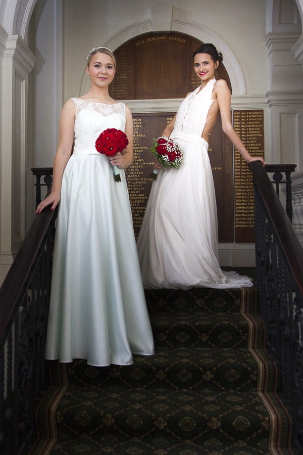 Brides on Stairs Holding Winter Wedding Bouquets with Red Roses