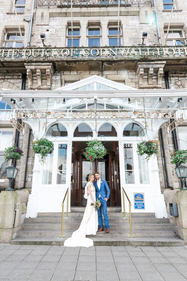 Bride and groom outside The Duke of Cornwall Hotel