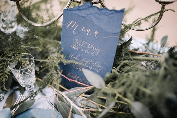 Blue wedding menu with gold calligraphy