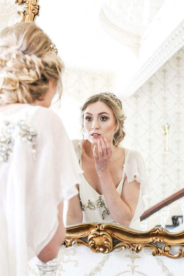 Bride checking make-up in mirror