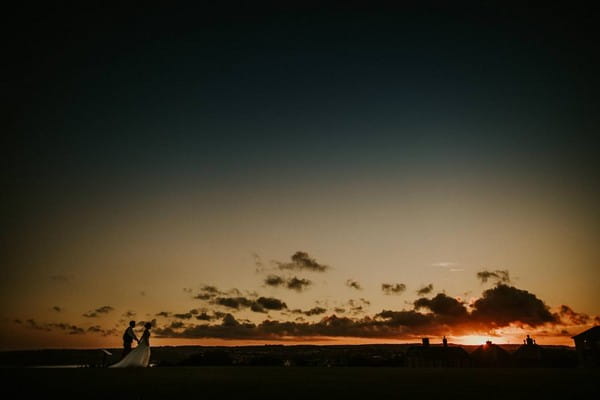 Bride and groom walking at sunset - Picture by Dan Ward Photography