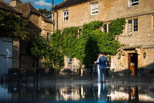 Bride and groom in courtyard of wedding venue - Picture by Nick Church Photography