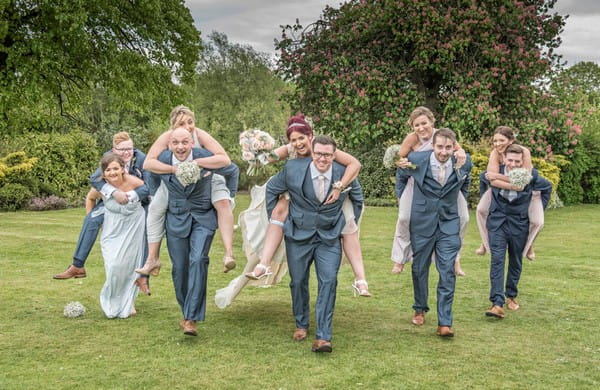 Groomsen giving bridesmaids piggyback ride - Picture by Image-i-Nation Photography