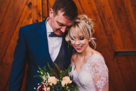 Bride smiling as groom rests his head on hers - Picture by The Struths