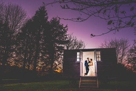 Bride and groom in cabin at night with purple sky - Picture by Shootinghip
