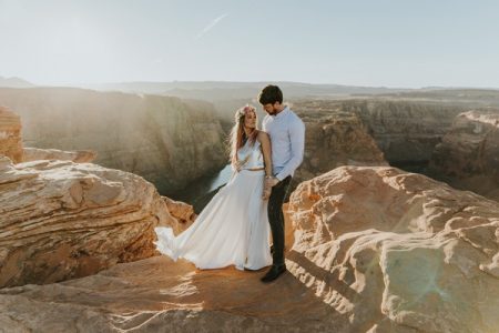 Bride and groom on rocks at the top of a mountain - Picture by Natalie J Weddings