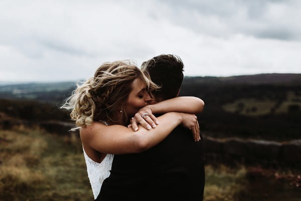 Bride and groom hugging in countryside - Picture by Luke Hayden Photography