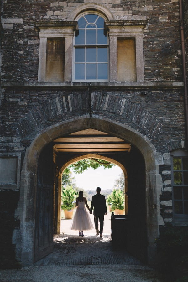 Bride and groom under arch