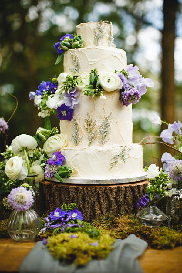 Wedding cake decorated with flowers on log slice