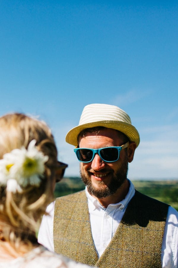 Groom wearing hat and sunglasses