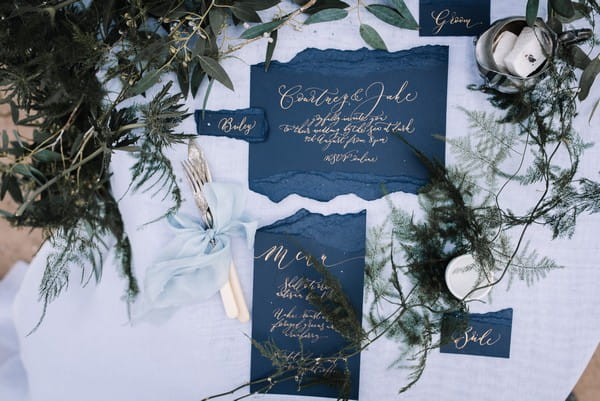 Blue wedding stationery with gold calligraphy lettering