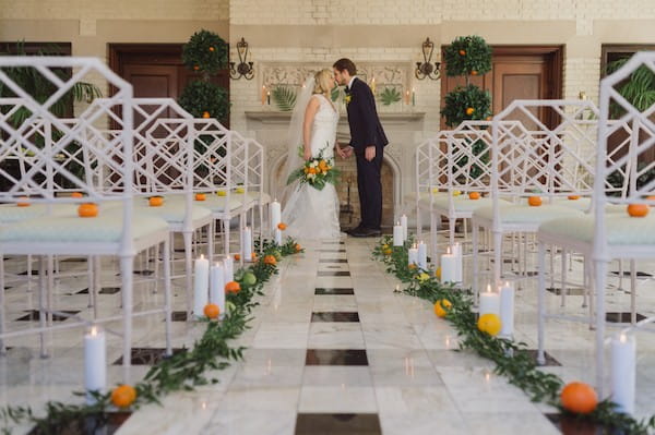 Bride and groom kissing in ceremony room